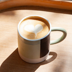 Hot coffee art latte on wooden table