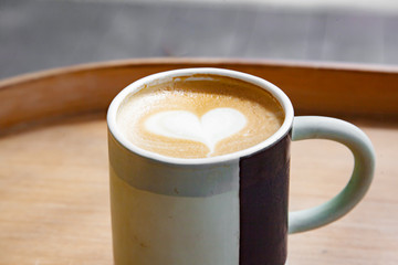 Hot coffee art latte on wooden table