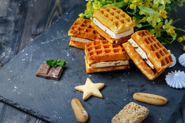 Near the spread of snow little meringue On graphite colors of flat stone meringue tiles there are shaped cookies