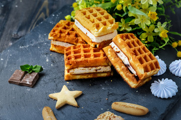 Near the spread of snow little meringue On graphite colors of flat stone meringue tiles there are shaped cookies