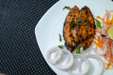 Delicious Fish fry with onions and lemon slice