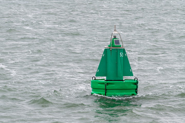 Green buoy as a marker for shipping .