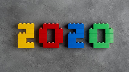 2020 numerals made of colorful plastic toy blocks on concrete textured background. top view. can be...