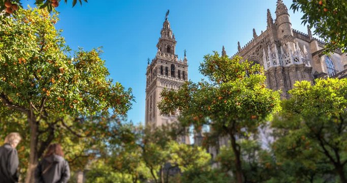 Timelapse of the Giralda Tower with blue sky and clouds passing behind. The Giralda Tower is in Seville, Andalusia, Spain. 4K, UHD, ultra HD resolution.