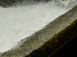 Water overflows the edge of the dam