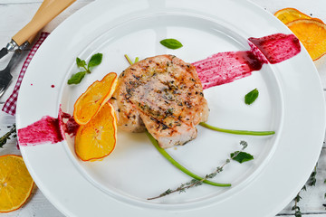 Grilled pork steak on a plate. Dishes, food. Top view. Free space for your text.