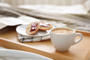 Morning coffee and sandwiches on tray in bedroom