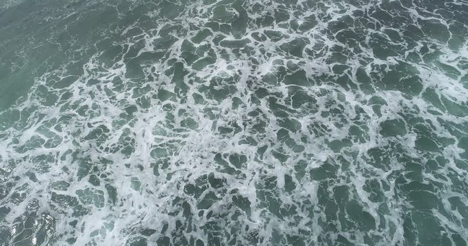 Aerial view. Aerial drone footage of ocean waves ,one turtle swimming in waves