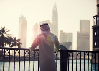 Arab man looking to Dubai skyline evening time