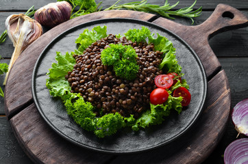 Boiled lentils with vegetables. Dishes menu. Free copy space. Top view.