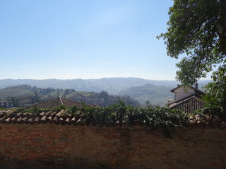 Panoramic view of a mountain landscape with expanse of roofs in the foreground