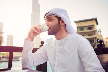 Arab man drink coffee in coffee shop in Dubai