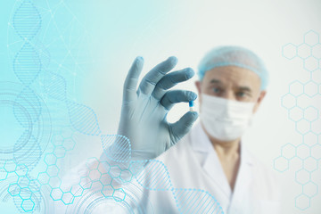scientist, an elderly man in a white coat and a protective mask holds a DNA capsule, the concept of...