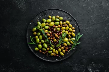 Poster Olives in a bowl, olive oil, spices and herbs. Top view. Free space for your text. © Yaruniv-Studio