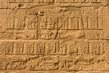 Fototapeta na wymiar Karnak Temple, Temple Ruins, Embossed hieroglyphics on columns. Great Hypostyle Hall.