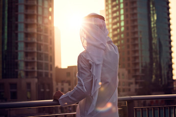 Arabic man looking to the sunrise, sunset Dubai