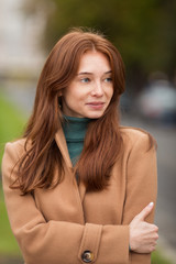 Fototapeta premium Young red hair woman portrait. Outside. Lifestyle. Vertical