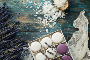 White and purple macarons or macaroons decorated with dry lavender flowers and coconut