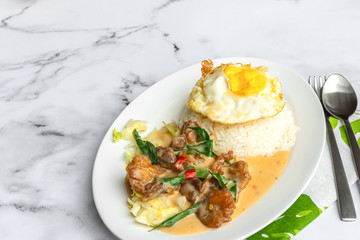 Creamy salted egg fried chicken with rice & egg. Asian food on table.