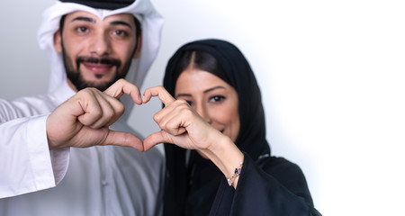 Arab couple making heart shape with hand fingers - valentines day love concept