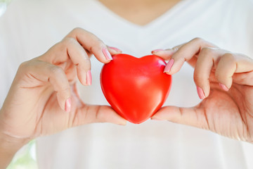 woman hand holding red heart ,healthcare ,donation ,love concept 