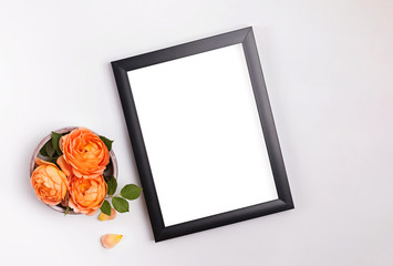 Minimalist mock up with empty frame and beautiful roses
