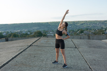 A young slim athletic girl in sportswear with snakeskin prints performs a set of exercises. Fitness...