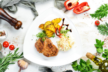 Pork steak with potatoes and sauerkraut. Top view. Free space for your text.