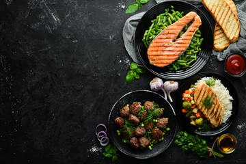 A set of dishes. Fish steak, chicken fillet, meat balls. Flat lay. Top view. Free copy space.