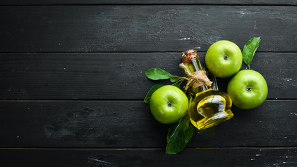 Apples and apple vinegar on the old background. Fruits. Top view. Free space for text.