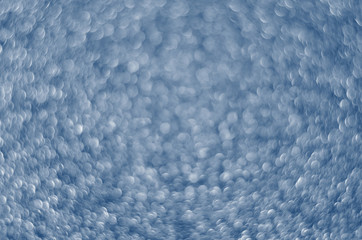 Obraz premium Classic Blue color. Color of the year 2020. Abstract festive bokeh background with shining defocus sparkles. Blurred glitters shimmering dust macro close up, copy space for text logo