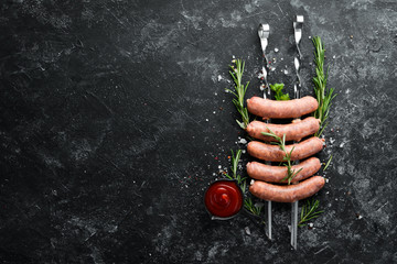 Raw Pork sausages with rosemary and vegetables. Top view. Free space for your text.