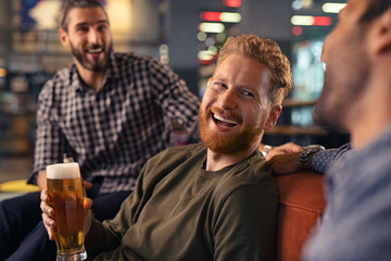 Friends enjoying draft beer at pub