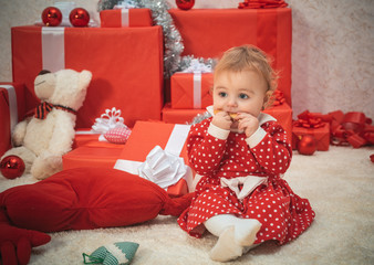 Cute baby girl in christmas costume. Family winter holidays and people concept. Bright New Year's interior. Happy little dreamy girl with christmas gift box. Happy new year. Elf child.