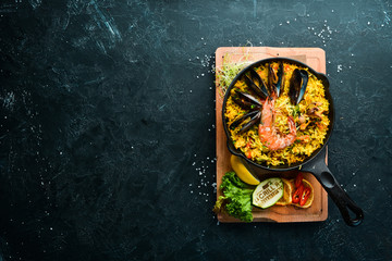 Seafood rice. Paella with mussels and shrimp. Top view. Free space for your text.
