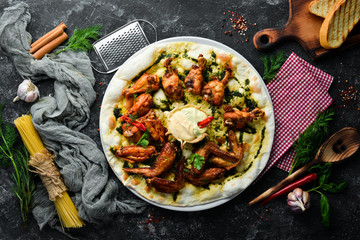 Grilled chicken wings. Pizza with chicken wings. Italian traditional cuisine. Top view. Free copy space.