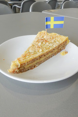 Piece of delicious sweet pear tart on white plate