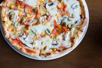 Close up Italian pizza with olives, tomatoes and che