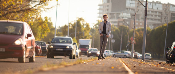 Businessman driving electric scooter in the city © Aleksandar