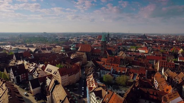 Aerial rising city with a castle and church in the foreground at beautiful sunrise in 4k