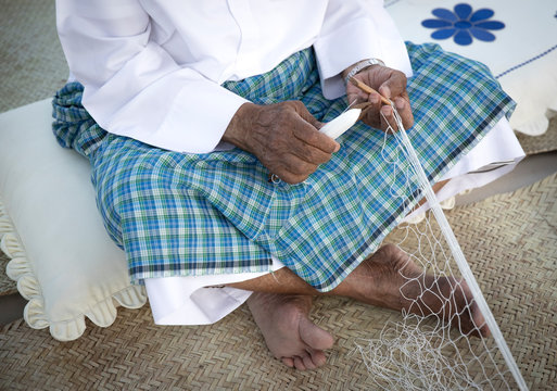 fisherman making nets