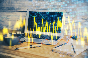 Double exposure of graph and financial info and work space with computer background. Concept of...