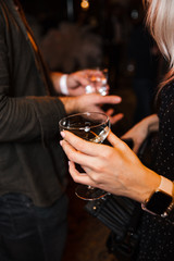People Chatting at a VIP business corporate event holding their champagne drinks and phones in Eastern Europe Latvia Riga bar cafe restaurant
