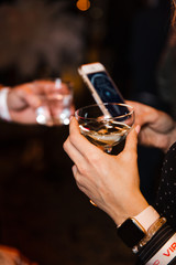 People Chatting at a VIP business corporate event holding their champagne drinks and phones in Eastern Europe Latvia Riga bar cafe restaurant