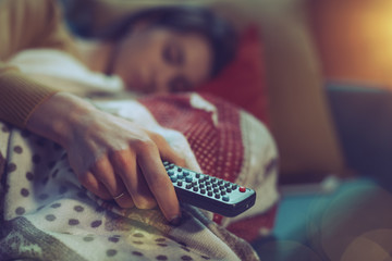 Woman falling asleep while watching TV
