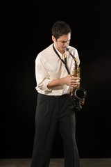 Fototapeta na wymiar Caucasian Businessman Blowing Saxophone