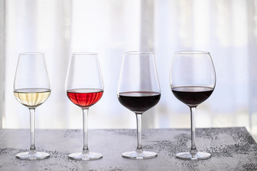 Trasparent glasses with different type of wine red, white, rose  and bordeaux on white background. Beautiful wine abstract background