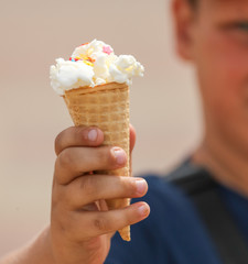 The boy eats an ice cream cone