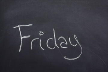Day of the week written on a blackboard with white chalk, friday