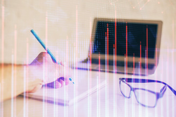 Multi exposure of man hands with stock market forex graph.